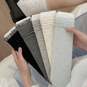 Close-up of ballet-style dotted socks in five colors with delicate lace ruffle cuffs
