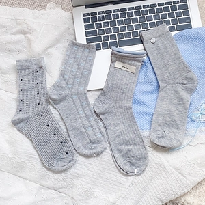 Detailed view of four gray cotton lace socks with heart patterns and textured knits