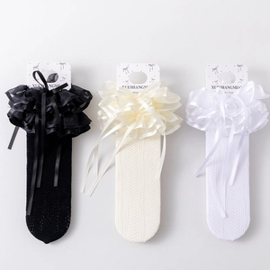 Close-up of three-color Lolita lace socks featuring organza ruffles and ribbon bows