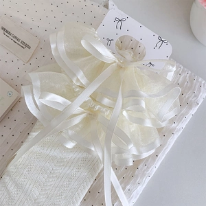 Close-up of lolita lace socks featuring ribbon bows and diamond hollow knit texture