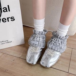 Silver metallic ballet-style sneakers with grey plaid ruffle trim and lace-up design