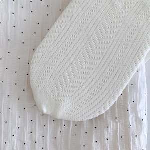 Detailed view of white Lolita lace socks featuring a delicate chevron knit pattern