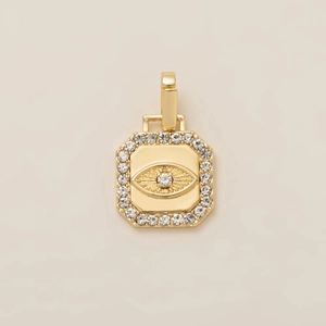 Macro detail of gold-plated octagonal Evil Eye pendant with sparkling zircon accents