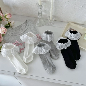 Detailed view of women's Lolita style socks with layered floral lace and ribbed knit texture