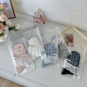 Detail of five-color lace trim socks in independent zipper bags with floral decor
