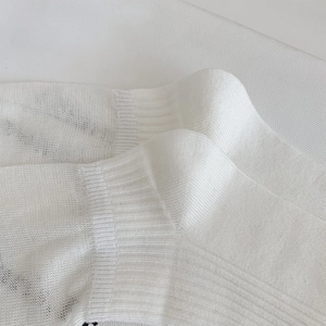 Detailed macro view of the ribbed cuff and knit texture on these white JK style socks