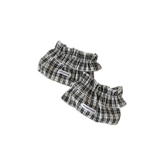 Chic black and white checkered leg warmers with ruffles and Mimorstudio woven label