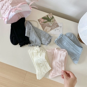 Detail of 5 pairs of frilly mesh socks in pastel colors with vintage hollow patterns