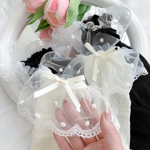 Close-up of polka dot lace mesh socks with ribbon bows in sweet Lolita style