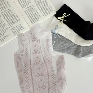 Detail of sweet bow tie knot and breathable mesh knit pattern on multi-color cotton socks