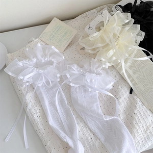 Detail of Lolita knee high socks with double layered lace trim and silk ribbons in three colors