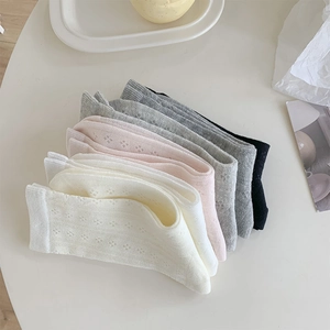 Detailed close-up of hollow flower mesh pattern on Morandi-toned breathable socks