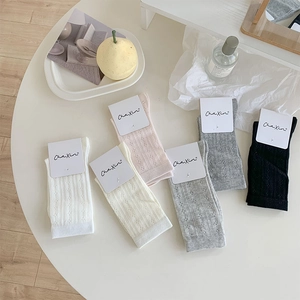 Detail showing hollow-out flower pattern and ribbed knit texture on six-color cotton socks