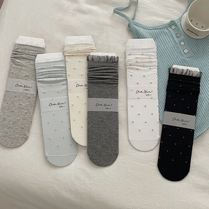 Detailed flat lay of six-pack ballet style polka dot socks with delicate lace cuffs