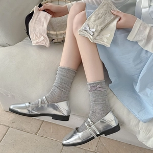 Detailed view of ballet-style mesh socks with silk ribbons in multiple colors
