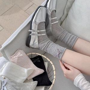 Detail of ballet style bow socks featuring breathable hollow mesh and ribbed cuffs