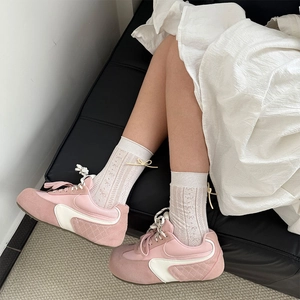 Pink and white platform sneakers with quilted texture and ribbon bow lace details