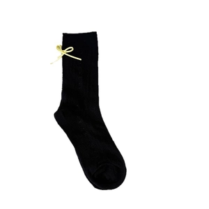 Japanese style black mesh socks with a delicate pale yellow silk bow detail for women