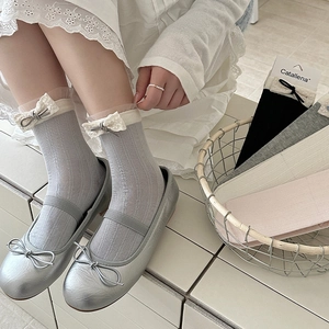 Lace-trimmed socks with bow accents in grey, white, and pink with Mary Jane shoes