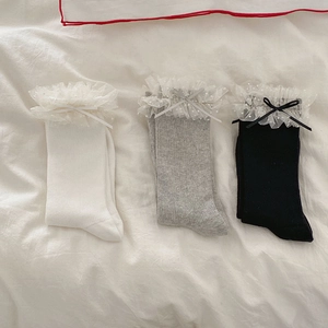Détails de trois paires de chaussettes côtelées avec dentelle à pois et nœuds