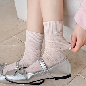 Detail of pink mesh knit socks with hollow floral patterns and high elasticity texture