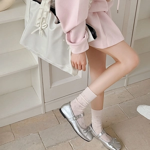 Ballet-style silver Mary Jane flats with bow detail and mesh hollow crew socks