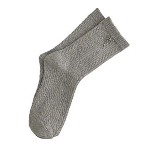 Mid-calf cable-knit socks for women featuring a delicate silver metal bow accessory