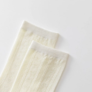 Detail view of breathable white mesh knit socks with vertical stripes and ribbed cuffs