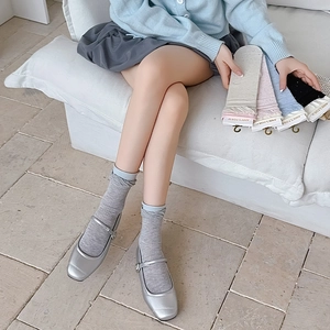 Detailed shot of ribbed knit crew socks in gray, beige and blue with contrast cuffs