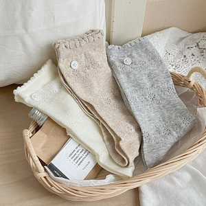 Detailed knit pattern on women's lace socks with decorative buttons and ruffles