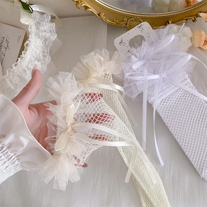 Close-up of Lolita mesh socks featuring intricate lace edges and satin bow details