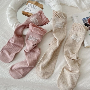 Detail of sweet bubble lace socks with Petit Maman embroidery in soft pink and beige colors
