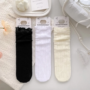 Detailed flat lay of breathable floral lace socks in black, white, and beige colors
