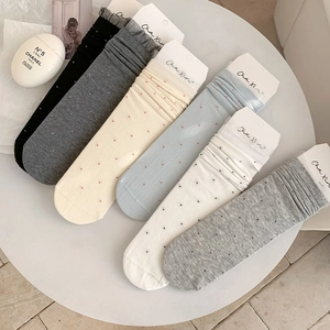 Detail of 6 colors of polka dot lace trim socks including black, white and grey shades