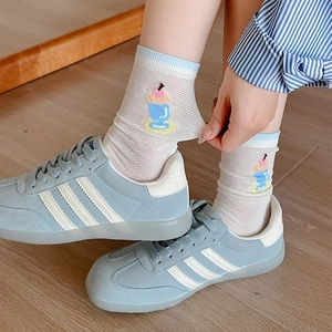 Detailed macro view of breathable white mesh socks with cute blue cartoon patterns