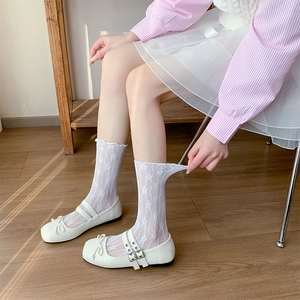 Detailed view of white floral lace socks with breathable hollow mesh and elastic texture