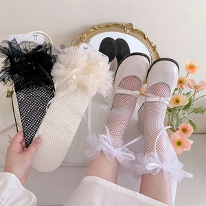 Lace ruffle knee-high socks with silk bow details paired with white Mary Jane shoes
