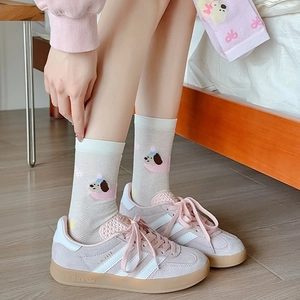 Close-up of white mesh socks with a cute cartoon puppy print and breathable texture