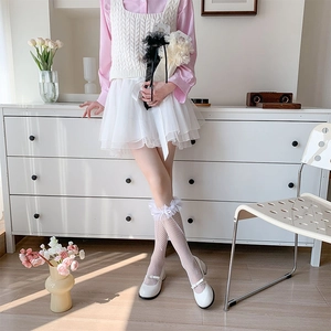 Detail of white lace mesh socks with delicate ruffles and bows for Lolita princess style