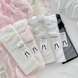 Detail of sheer mesh Lolita socks with delicate bow ties in multiple pastel colors