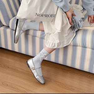 Silver Mary Jane shoes with square toe and buckle paired with blue bow socks