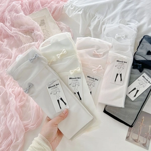 Close-up of lolita mesh socks with delicate ribbon bows in various soft pastel colors