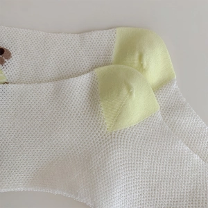 Close-up of breathable white mesh socks featuring cute brown cartoon bear embroidery