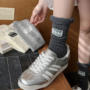 Japanese style slouch socks with white lace patches in dark grey, light grey, and cream