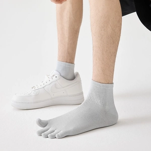 Close-up of men's grey five-finger socks showing toe separation and ribbed cuffs