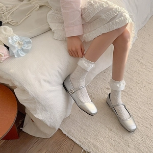 Detail of silver Mary Jane shoes paired with white lace hollow ruffle socks in sweet style