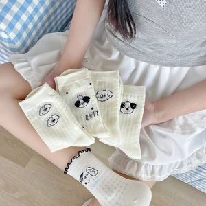 Close-up of beige cotton socks with cute cartoon dog patterns and breathable mesh texture