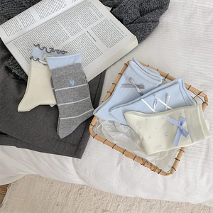 Detail of bow-knot socks and heart embroidery with ruffled edges in a cute Japanese style