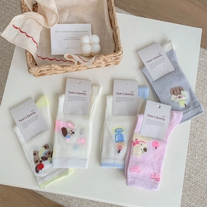 Detail of five cute cartoon mesh socks with breathable patterns and paper tags