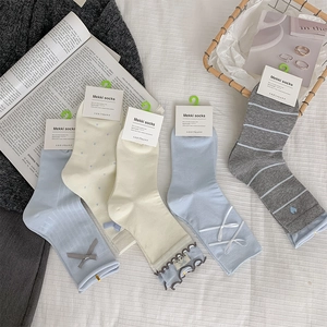 Detail of five-pair set of cute bow-knot crew socks with ruffled edges in assorted pastel colors